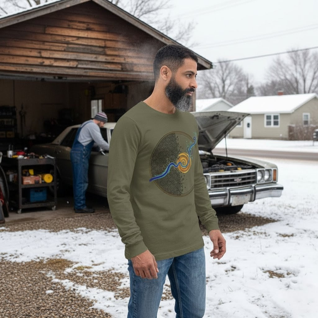 Man wearing a green t-shirt with a graphic design, standing in a snowy driveway with a car and garage in the background.
