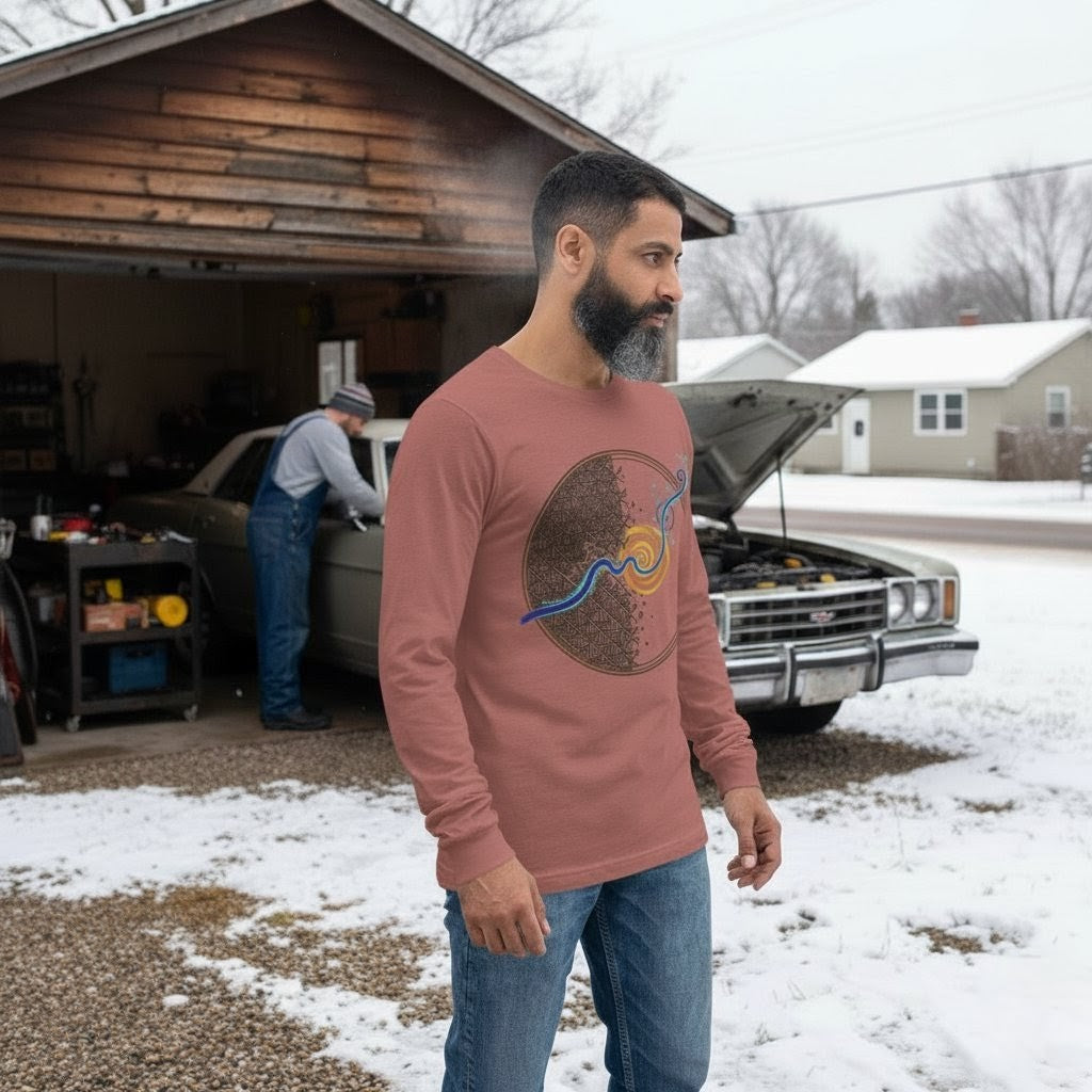 Man wearing a pink long-sleeve shirt with a graphic design, standing in a snowy driveway with a car and garage in the background.