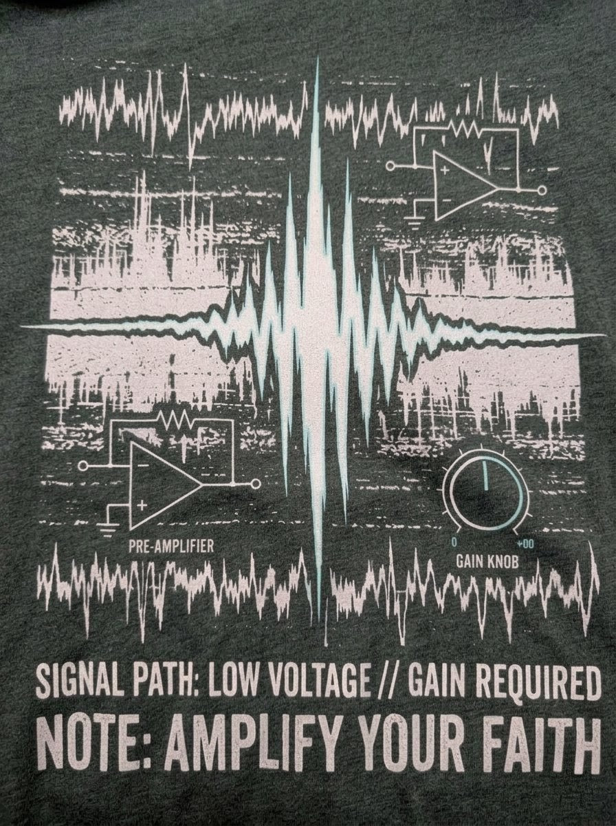 "Detailed view of the Selah Supply Co. 'Gain' graphic, showing the pre-amp schematic and the high-voltage waveform spike cutting through chaotic static, designed as a conversation-starting piece of Christian apparel."
