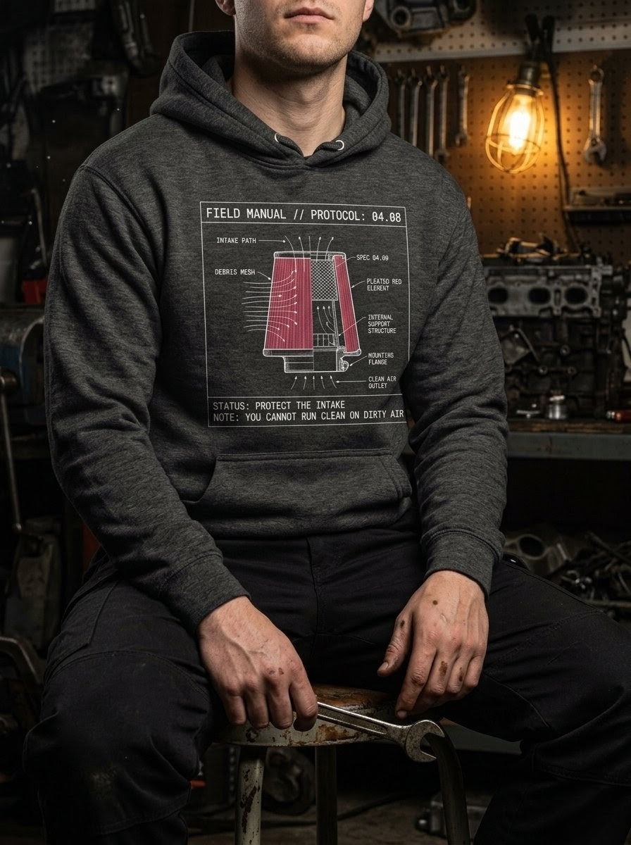 An operator wearing the charcoal Intake hoodie. The chest graphic features a detailed industrial schematic of the Philippians 4:8 specification mesh, representing the soul's dependency on clean information.