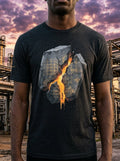 Person wearing a black t-shirt with a graphic design of a熔岩流 through a cityscape against a sunset industrial background.