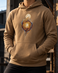 Model wearing the Latte Edify Hoodie with interwoven golden figures rising toward a light.