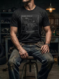 A seated model in the black heather Component Navigation tee, illustrating the 'Story of the Fog' concept from the Protocol Collection.