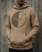 Model wearing the Latte Rewire hoodie with circular grid and spiral artwork.