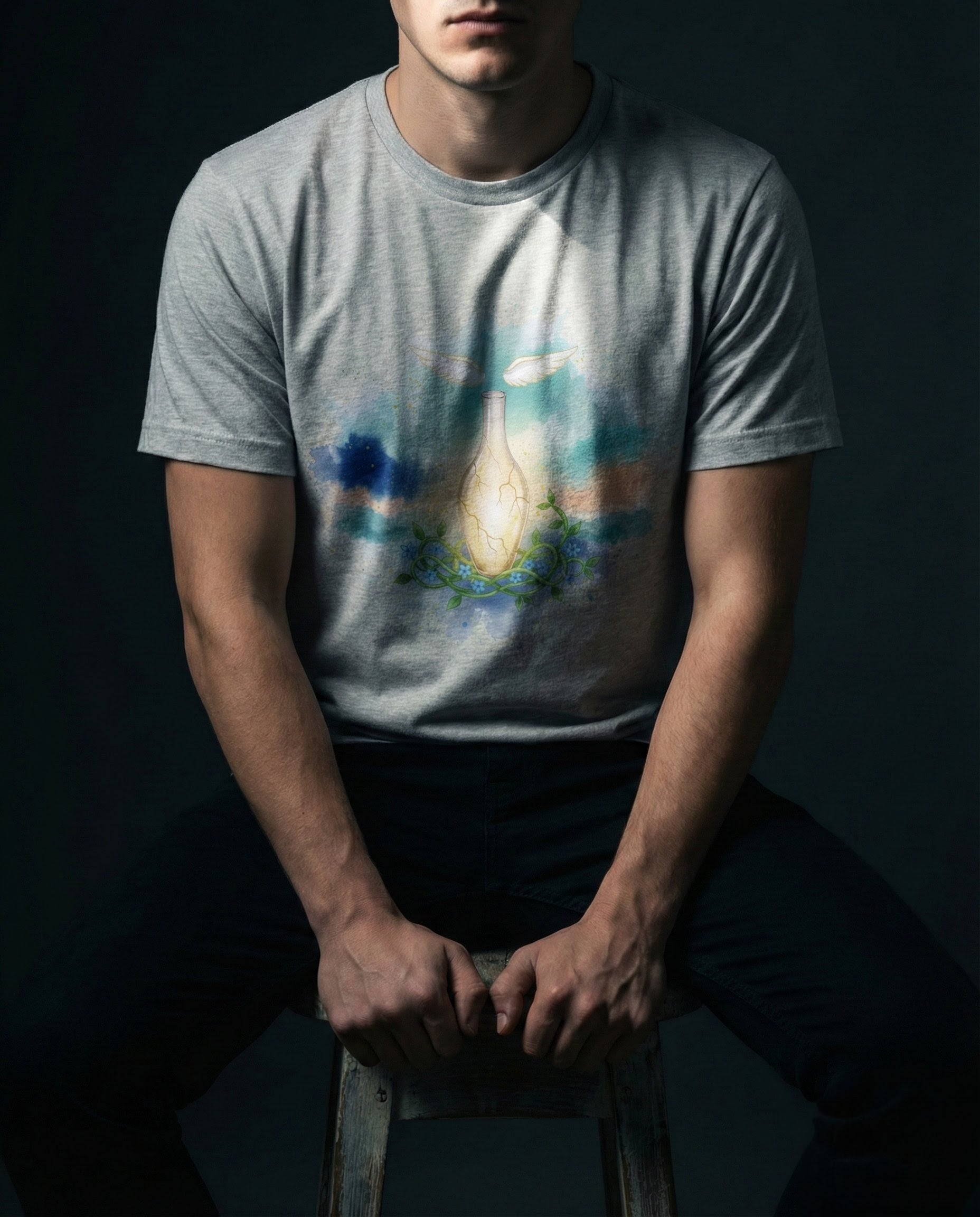 Person wearing a t-shirt with a colorful graphic design on a dark background