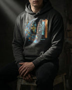 Model wearing a Charcoal Heather Separation Hoodie with geometric fish-like forms, dark fragments, a net-like grid and a red dividing line printed on the front.