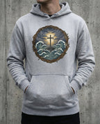 Model wearing the Carbon Grey Trouble Hoodie with cross above storm waves within a thorn border.
