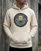 Model wearing the Bone Trouble Hoodie with cross above storm waves within a thorn border.