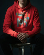 Model wearing the Team Red Bushel Hoodie with geometric lamps, teal and gold rays, colored blocks and a black grid.