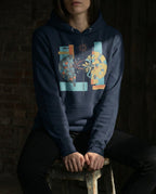 Model wearing the Navy Blazer Output Hoodie with a divided dark and golden sphere with red lightning, a branch and blue flowing lines.