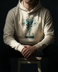 Selah Supply Co. Bone (off-white) 'The Thirty Sixty Hundred Hoodie.' Model wearing a scripture-based hoodie illustrating the hundred-fold harvest of the good soil. High-quality Christian streetwear designed for deep theological conversation.