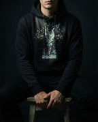 Model wearing the Black Thirty Sixty Hundred Hoodie with a tall teal, navy and gold spray of seeds and leaves above small seedlings.