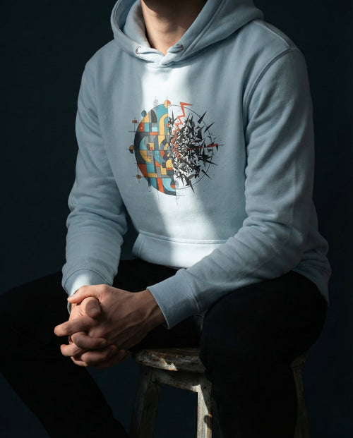 Person wearing a light blue hoodie with a colorful abstract design on a dark background