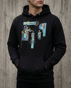 Model wearing the Black Insolvent Hoodie with geometric creditor and debtor figures, stacked gold and tangled black lines.