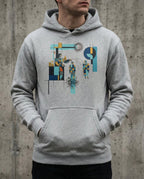 Model wearing the Carbon Grey Insolvent Hoodie with geometric creditor and debtor figures, stacked gold and tangled black lines.
