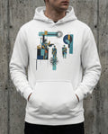 White hoodie with abstract design worn by a person against a concrete wall.