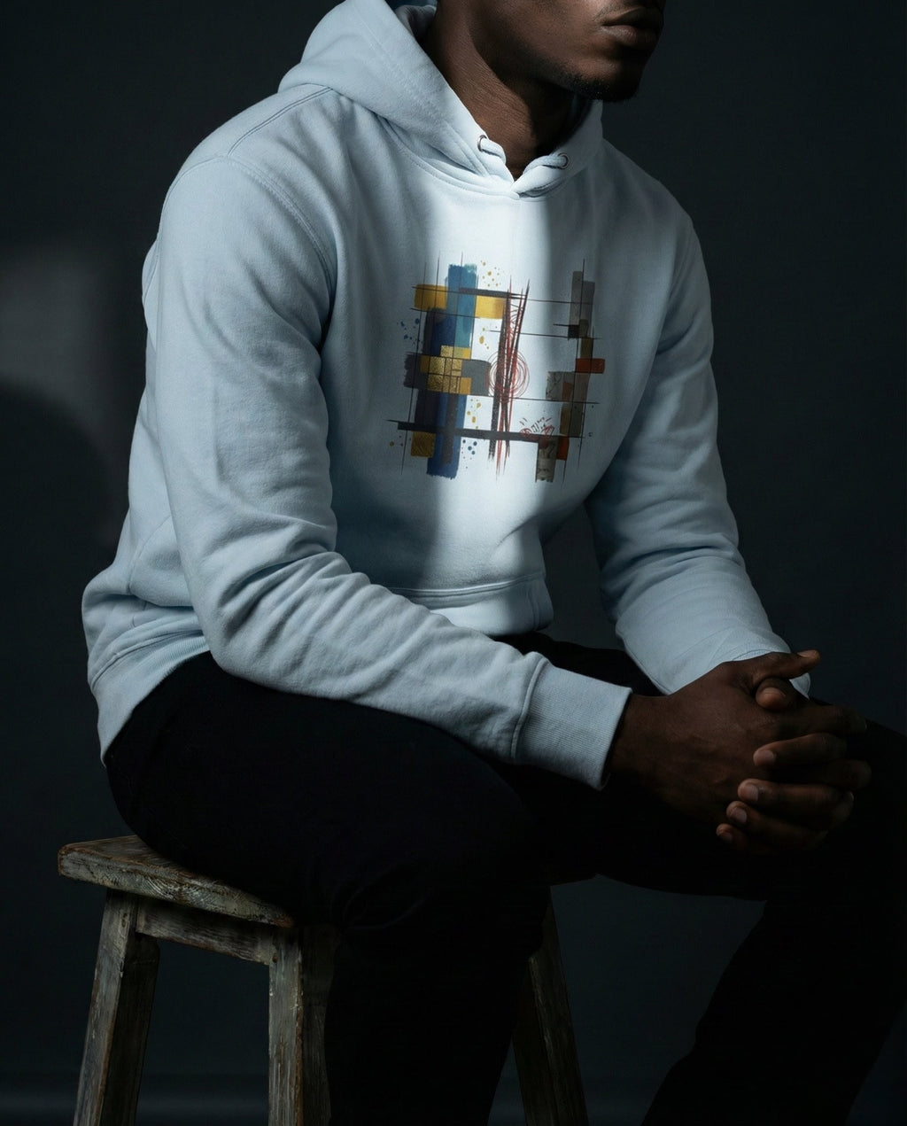 Model wearing the Sky Blue Lazarus Hoodie with gold, blue, grey and rust geometric artwork.