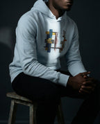 Model wearing the Sky Blue Lazarus Hoodie with gold, blue, grey and rust geometric artwork.