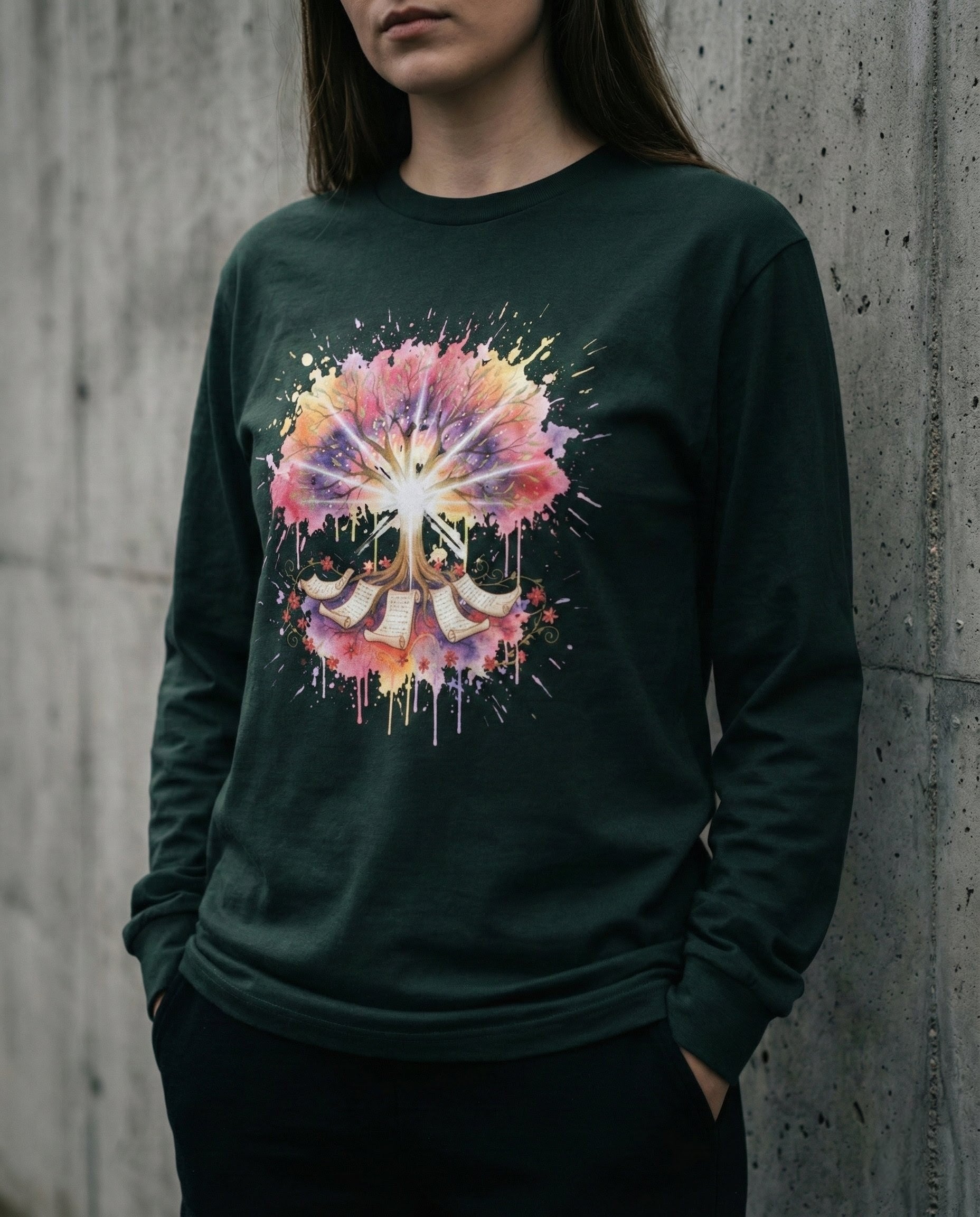 Person wearing a dark green sweatshirt with a colorful abstract design against a concrete wall.