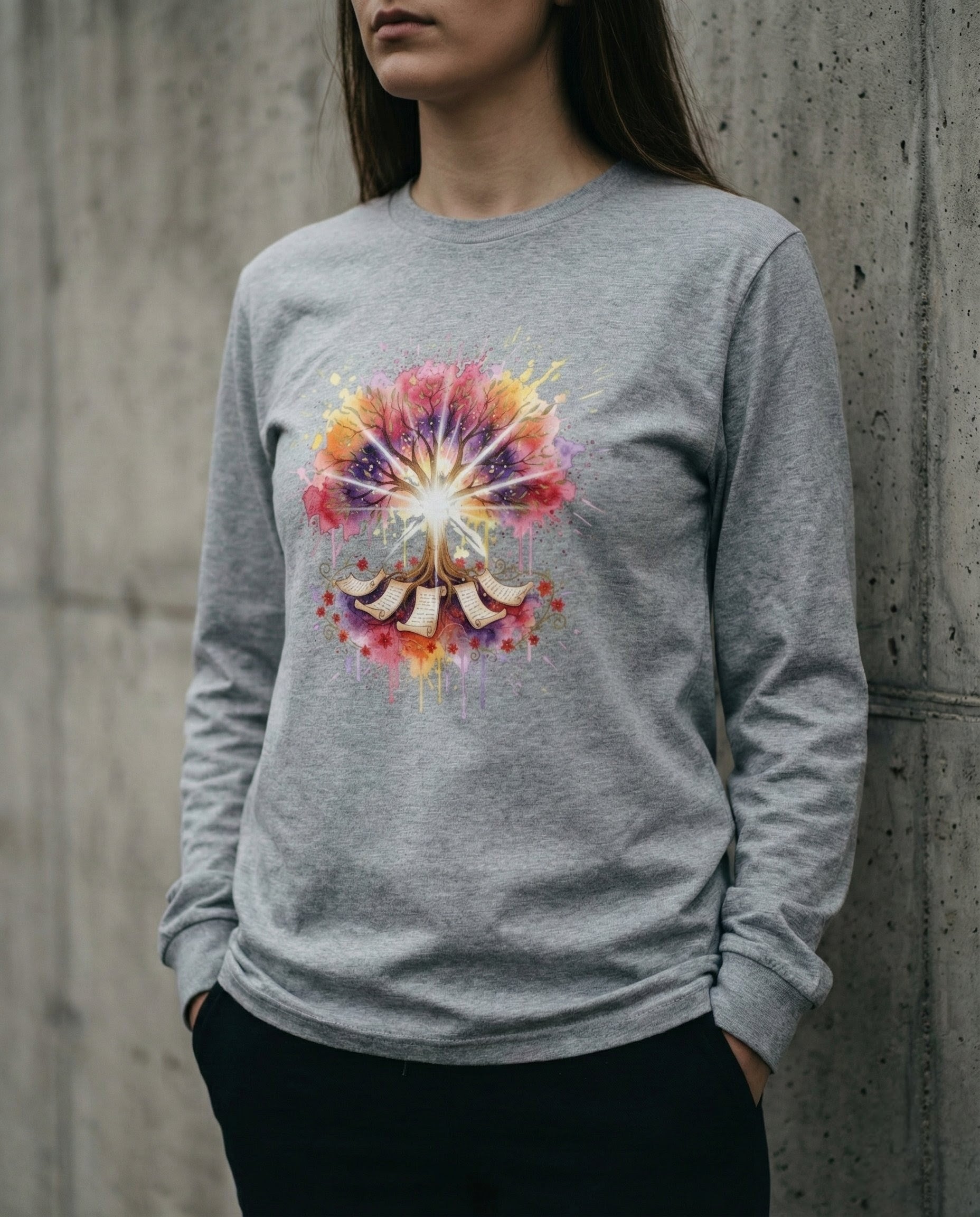 Person wearing a gray sweatshirt with a colorful mandala design against a concrete wall.