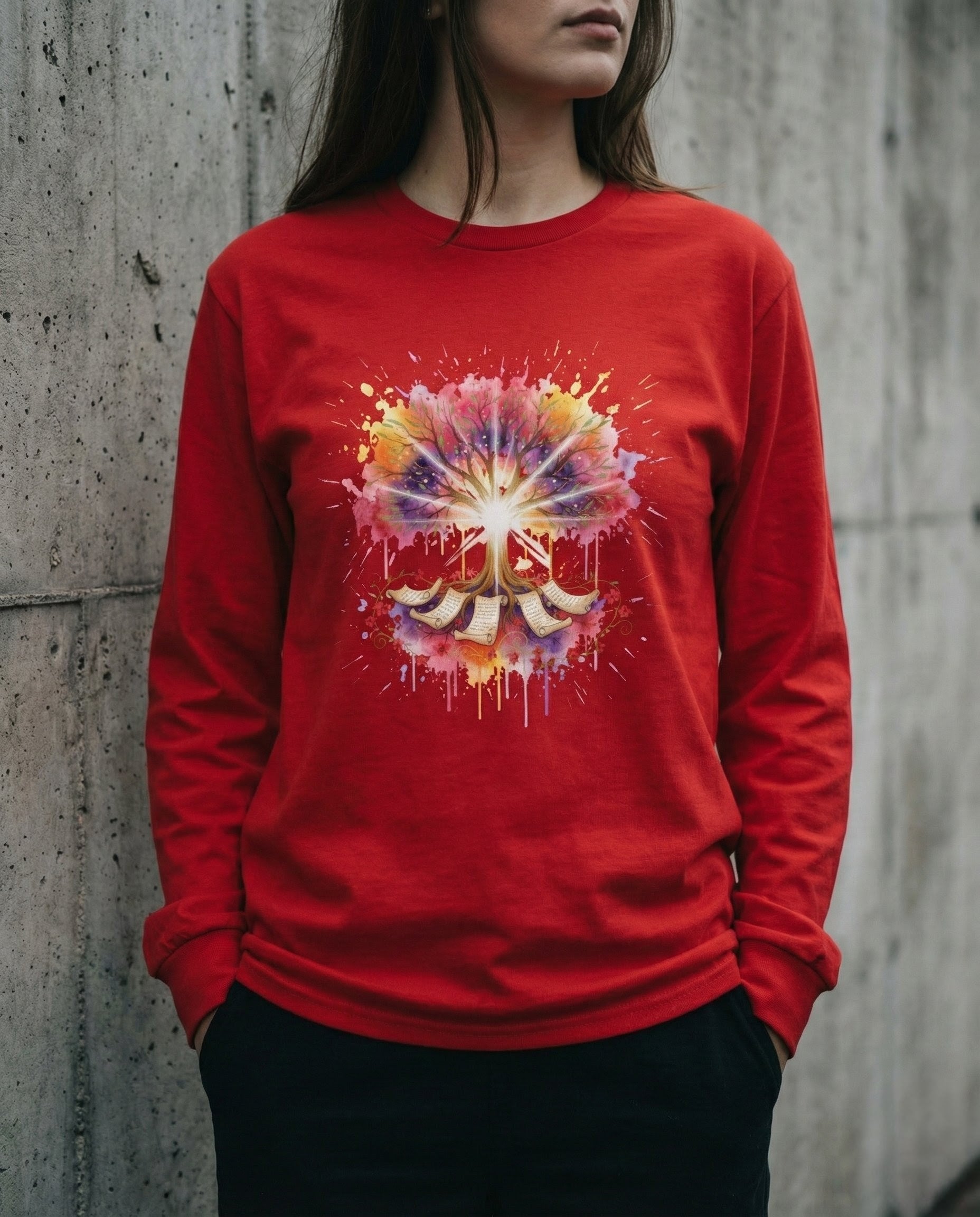 Person wearing a red long-sleeve shirt with a colorful abstract design against a concrete wall.