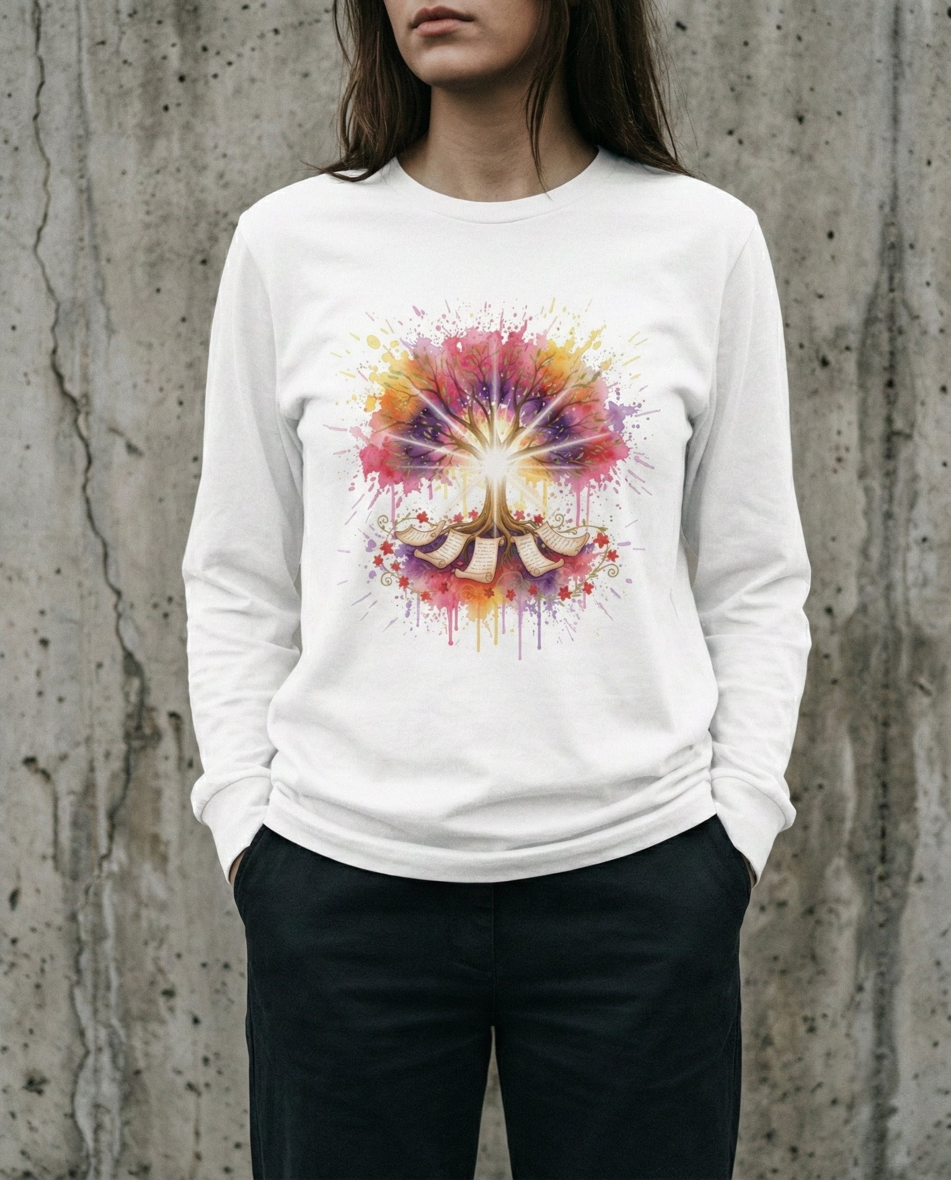 Person wearing a white sweatshirt with a colorful abstract design against a concrete wall.