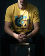 Model wearing the Yellow Ex Nihilo Tee with abstract vortex, red line and geometric grid artwork.