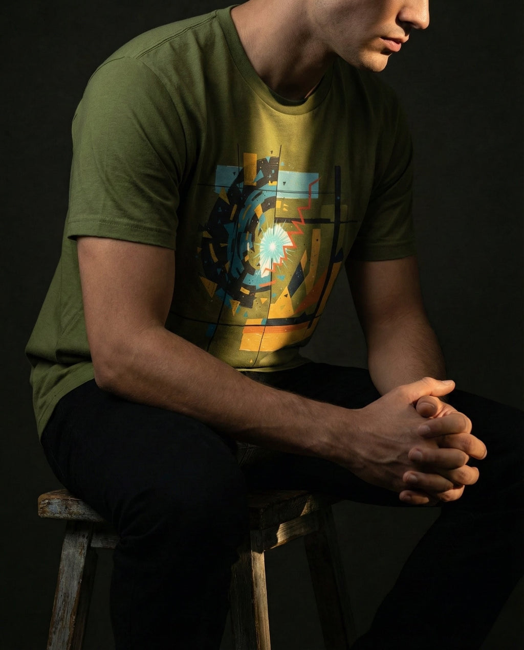 Model wearing the Olive Ex Nihilo Tee with abstract vortex, red line and geometric grid artwork.