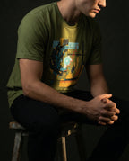 Model wearing the Olive Ex Nihilo Tee with abstract vortex, red line and geometric grid artwork.