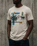 Selah Supply Co. The One Percent Tee in Heather Dust. Model wearing a Christian graphic tee that visualizes the Parable of the Lost Sheep (Luke 15) through an abstract design of a blue flock, an isolated sheep, and a red scribble of chaos.