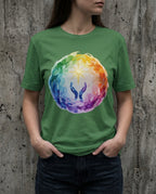 Model wearing the Heather Grass Green Supplication Tee with a rainbow ring surrounding raised blue hands and a golden starburst.