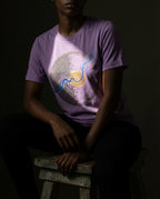 Front view of a model wearing the Heather Team Purple Rewire tee with circular grid and spiral artwork.