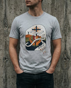 Model wearing the Athletic Heather Lean Not Tee with hands, geometric heart, winding white path and cross artwork on the front.