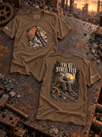 Heather brown T-shirts laid front and back on rusted steel; the front shows broken pottery, cloth, and a metal tool in ash, and the back shows THE UZ STRESS TEST above a seated figure in ruins.