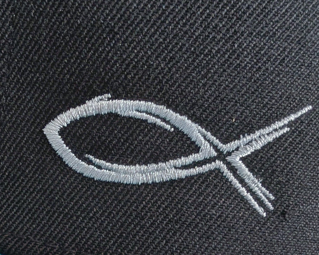 Embroidered fish symbol on a dark fabric background