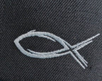 Close-up of white sketch-style fish embroidery on dark cap fabric.
