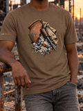 Model wearing a heather brown T-shirt with a broken terracotta pot, draped cloth, a pointed metal tool, and ash with a glowing ember on the front.