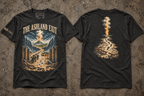 Charcoal heather T-shirts laid front and back on concrete; THE ASHLAND EXIT fronts a scene of figures between blue waves, while the back shows footprints, broken chains, and a column of fire and smoke.