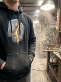 Model wearing the Selah Supply Co. Black Transmission: Breach // Freq: 02.17 streetwear hoodie, showcasing the brutalist front graphic with its intense glowing amber blueprint grid.