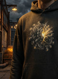Model wearing the Selah Supply Co. Transmission: Chariot // Freq: 01.16 streetwear hoodie in a dark industrial environment, showcasing the high-contrast glowing wheel-within-a-wheel front graphic.
