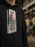 Model wearing the Selah Supply Co. Black Transmission: Override // FREQ 05.01 streetwear hoodie, showcasing the high-contrast vertical brutalist spine graphic with glowing red accents.